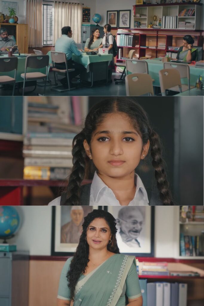 Film still showing a school office interior with soft daylight. A young schoolgirl in uniform is framed in a close-up, looking directly at the camera, followed by a medium shot of a woman teacher in a green saree standing in the same space, creating an emotional visual contrast.